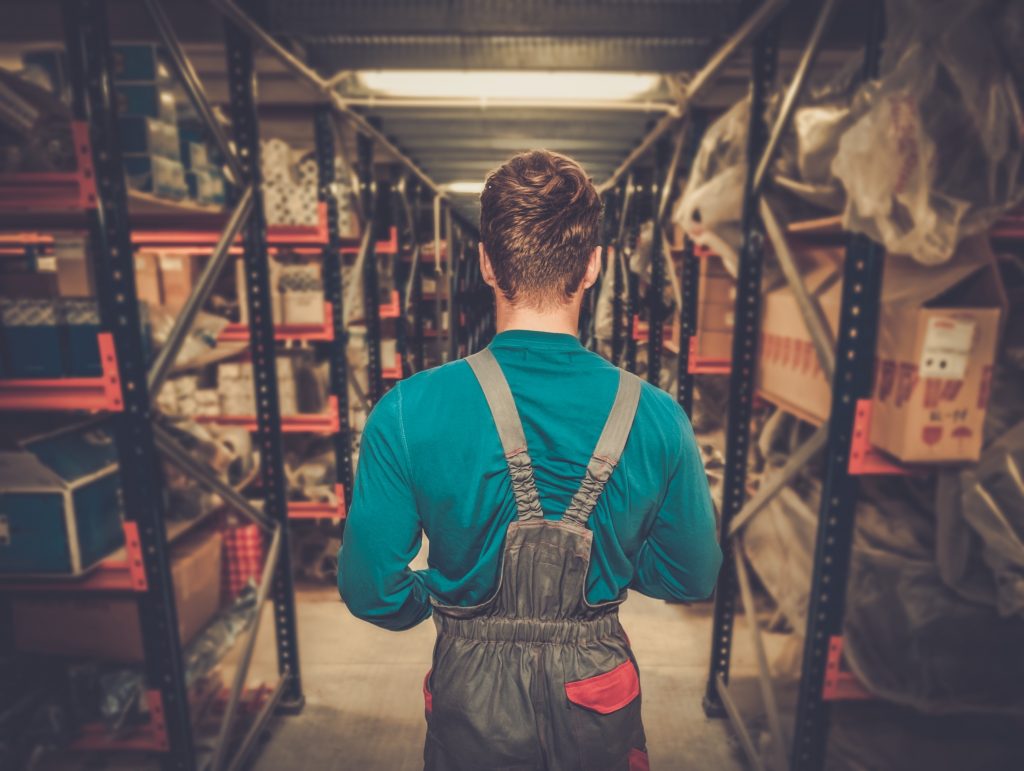 Worker in a warehouse full of shelves