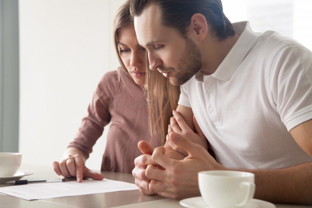 couple checking home sale contract