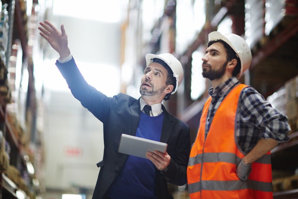 men talking wearing safety helmets