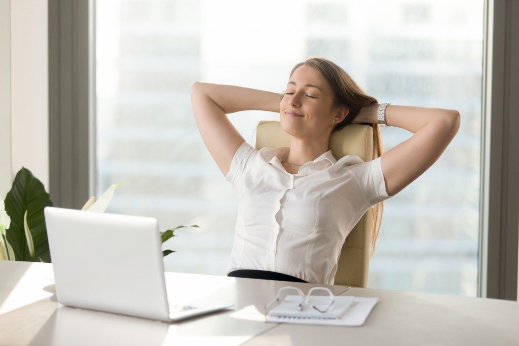 woman comfortably sitting on her chair