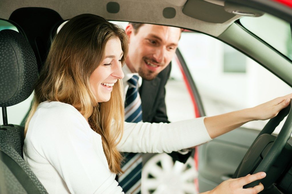 Man showing the car to the woman