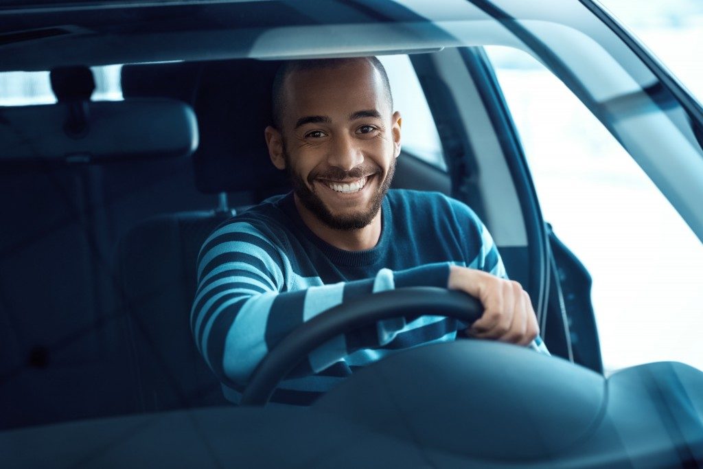 Smiling man in his car