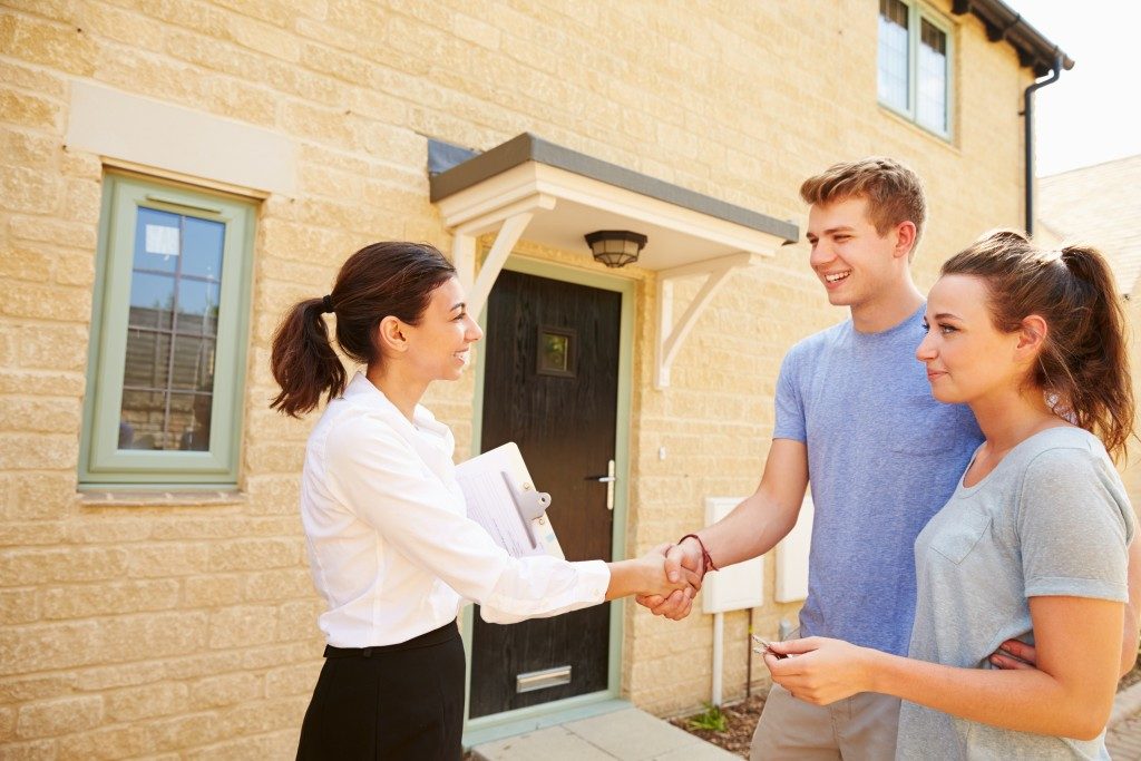 Agent shaking the hand of the new house owner