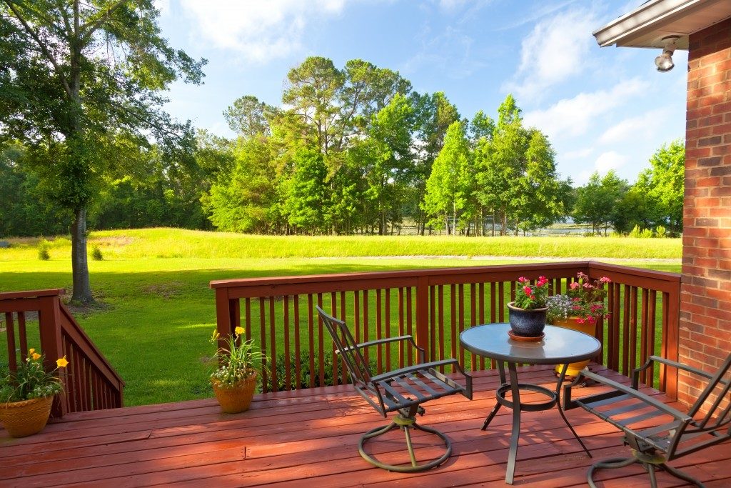 Residential backyard patio overlooking lawn and lake