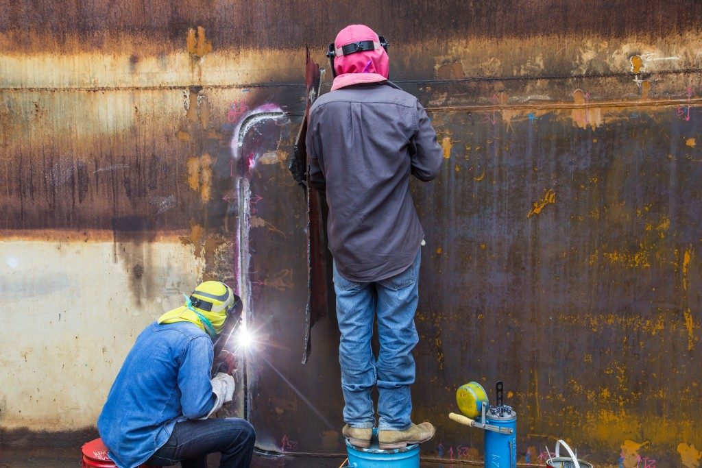 men in welding gear