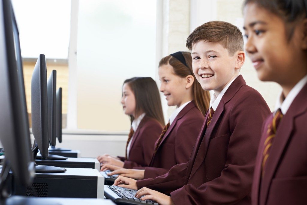 Pupils wearing school uniform in computer class