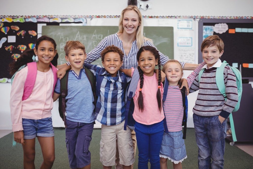 Kids posing with their teacher