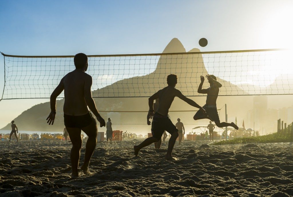 boys playing beach volleyball