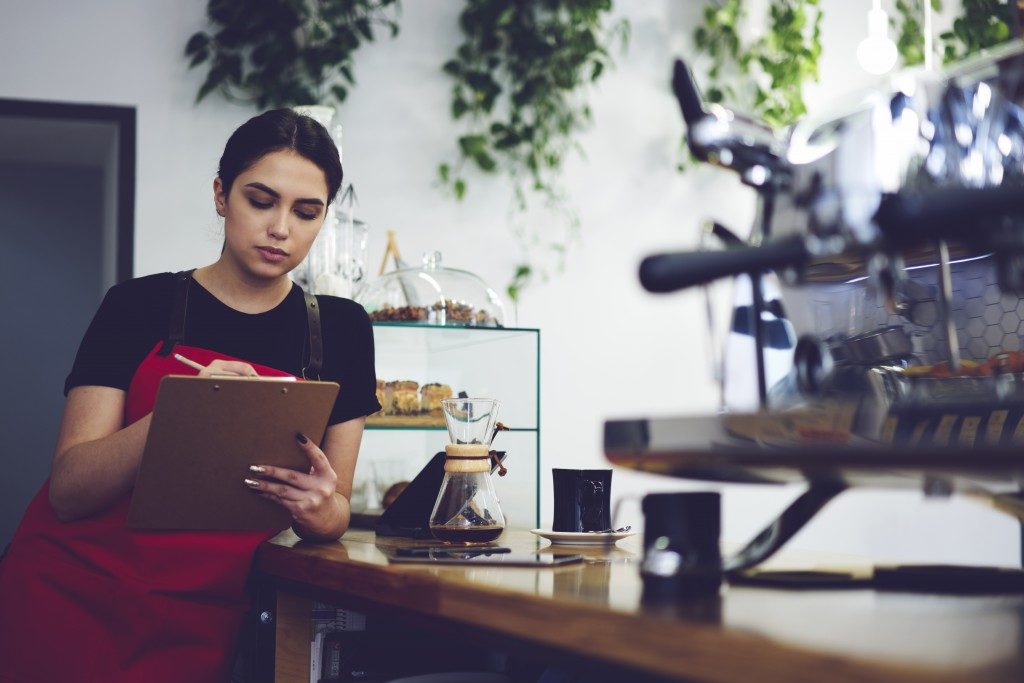 coffee shop owner checking her documents