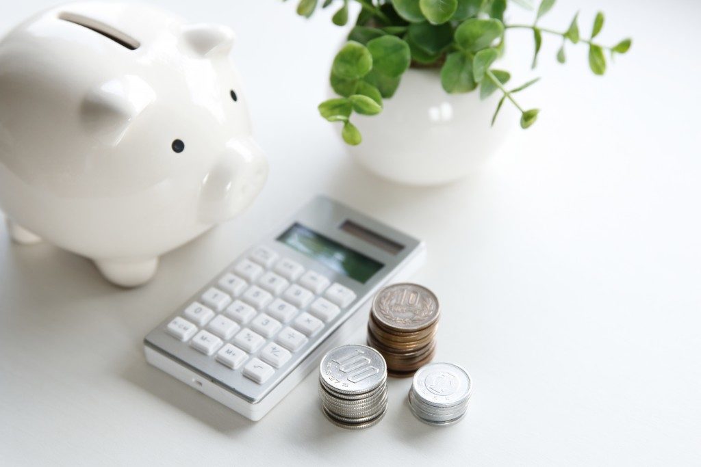 Coins, calculator and piggy bank