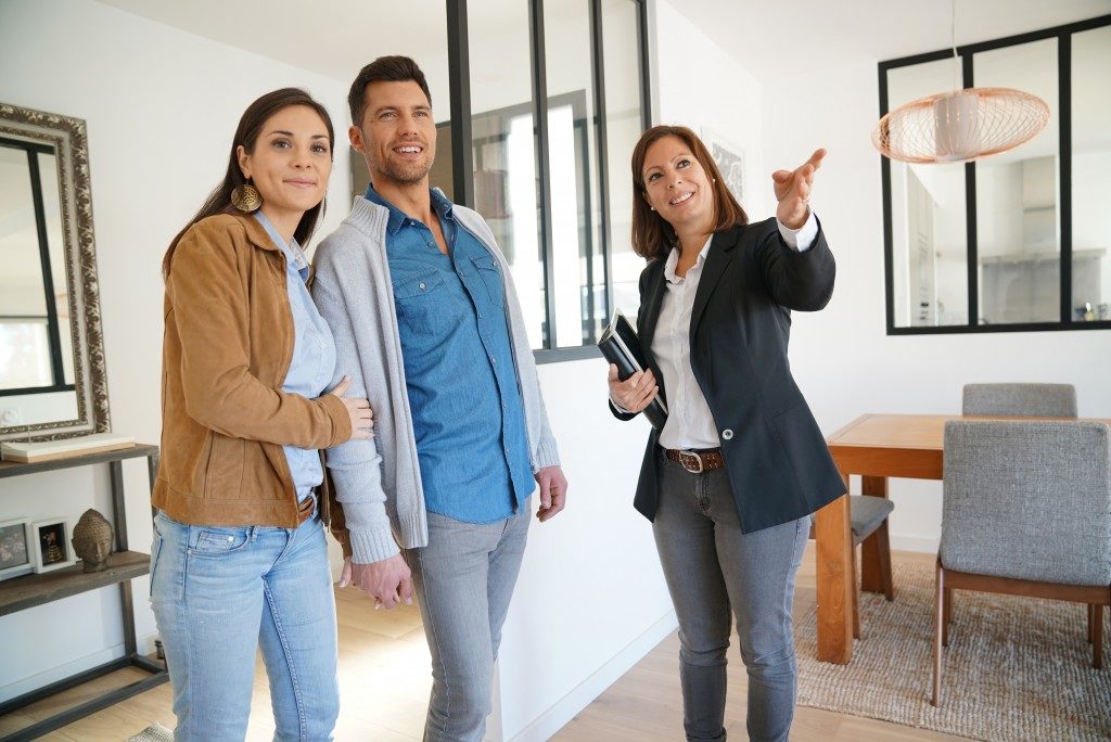 real estate agent touring a couple