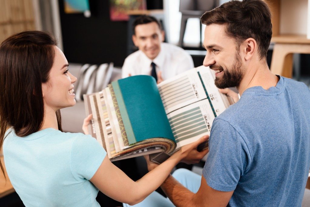 couple looking at magazine of swatches