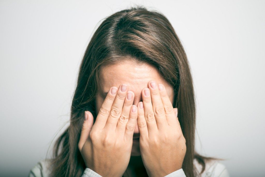 worried woman covering her face