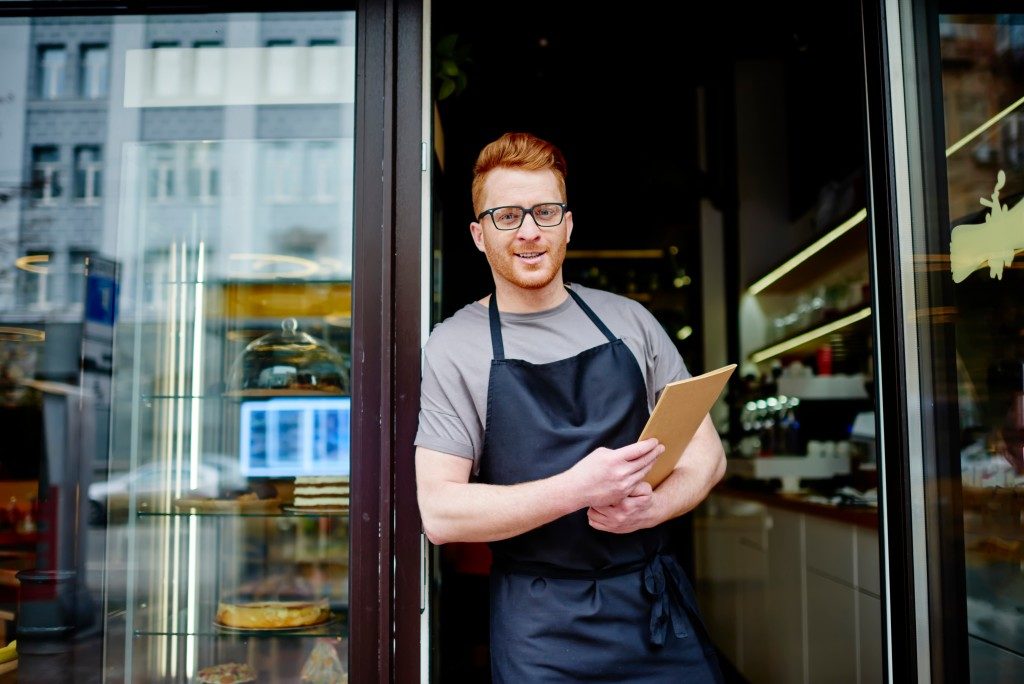 Man standing outside his shop