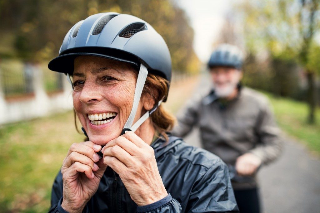 Couple wearing helmets for cycling