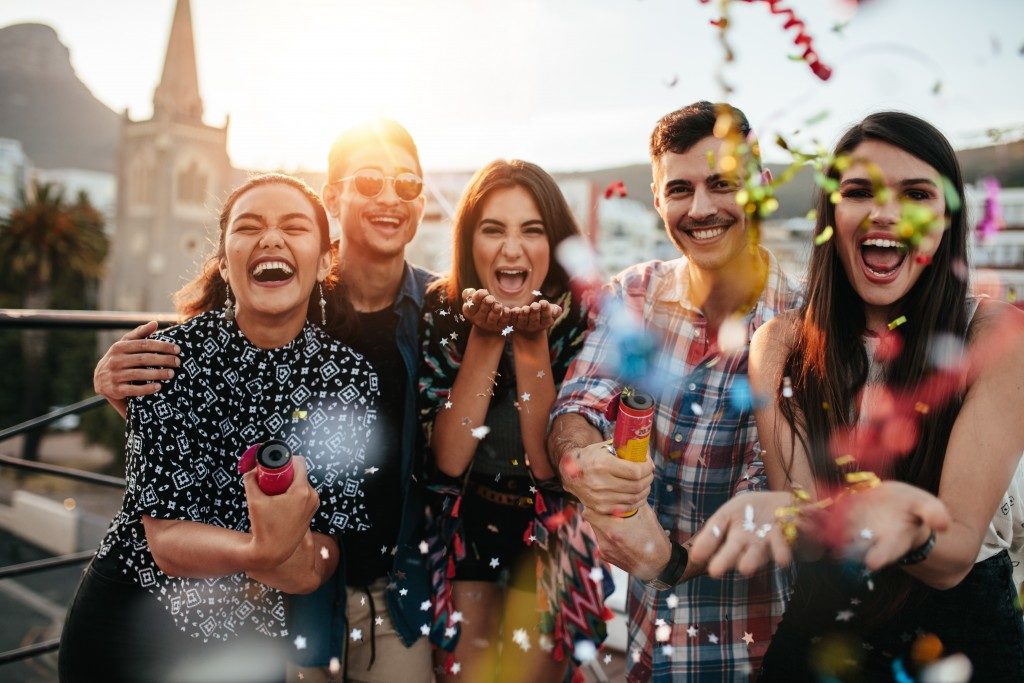 Friends throwing confetti for birthday surprise