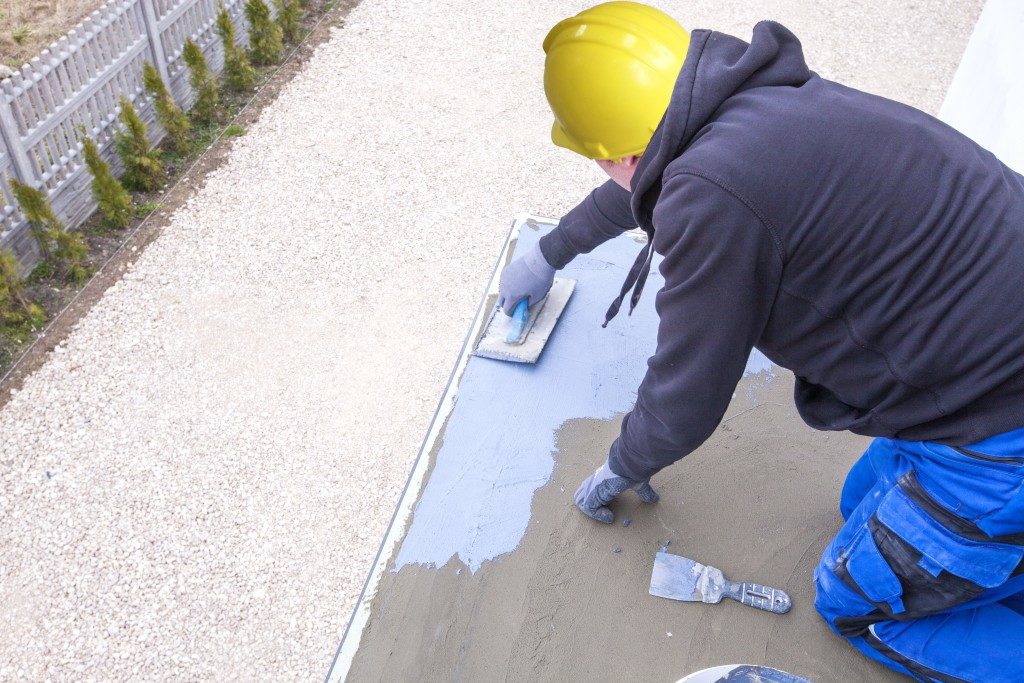 Construction worker applying sealant