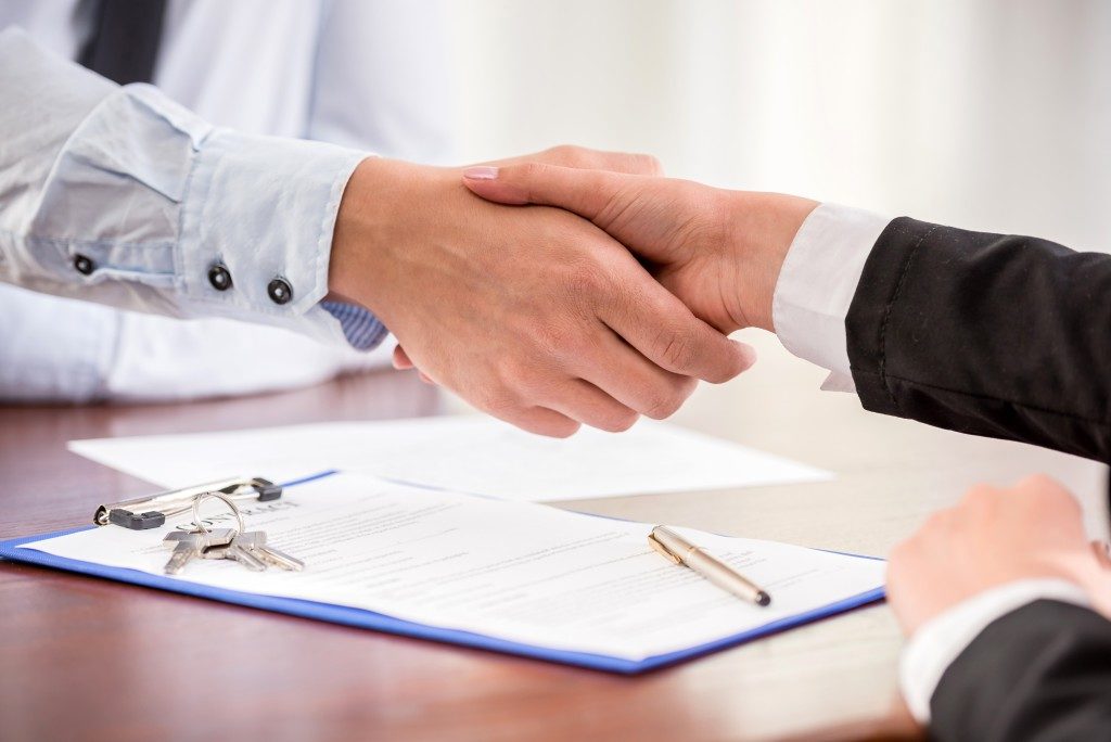 Handshake of a real estate agent and a client.