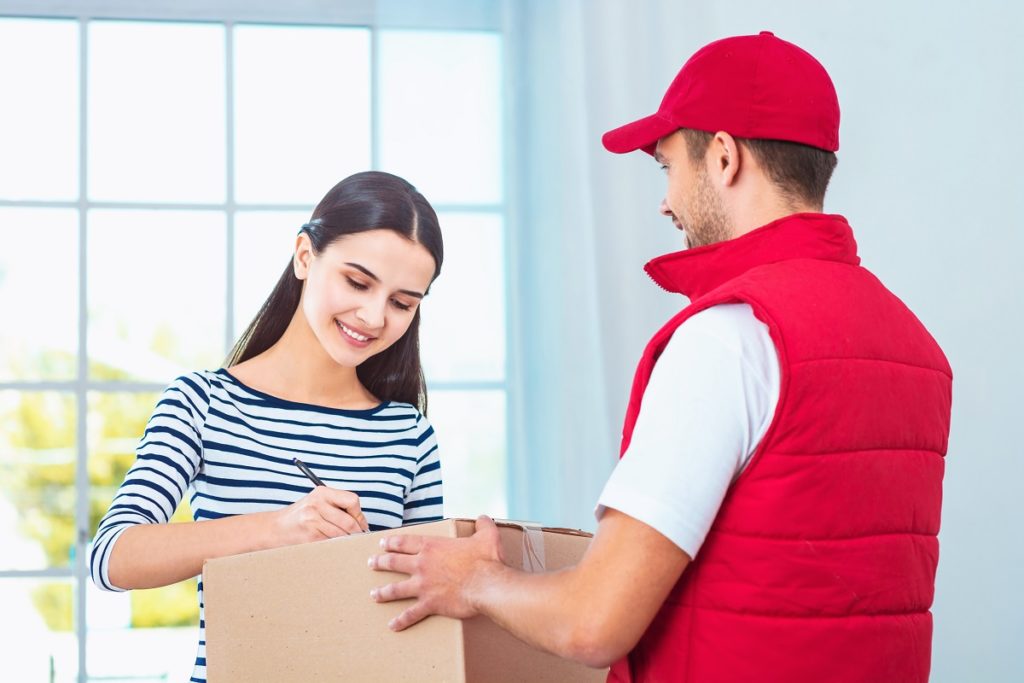 delivery of package, woman signing paper