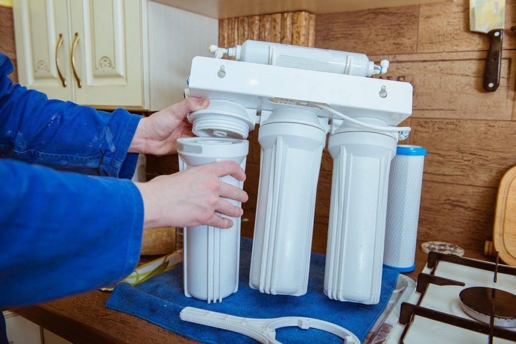 Man installing water filter