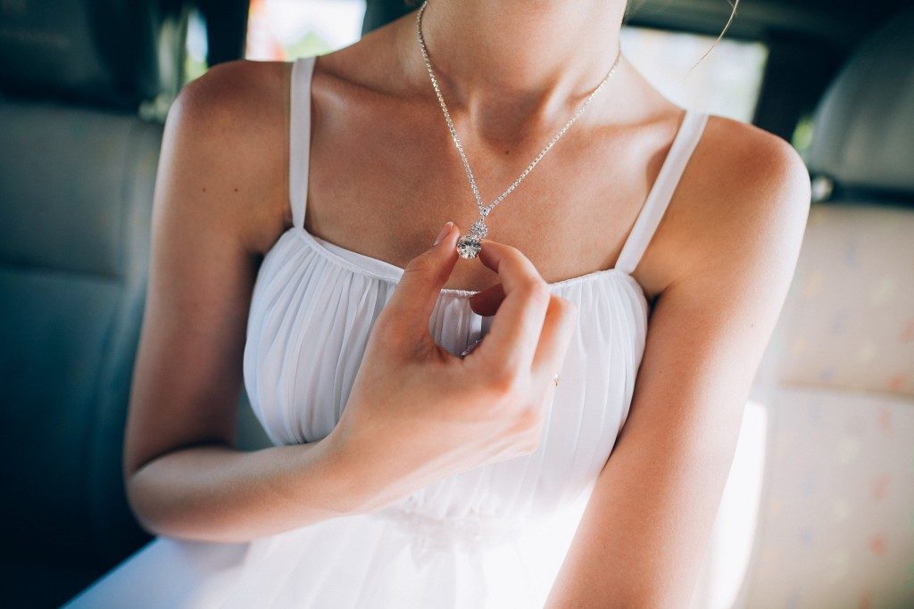 Female wearing silver necklace