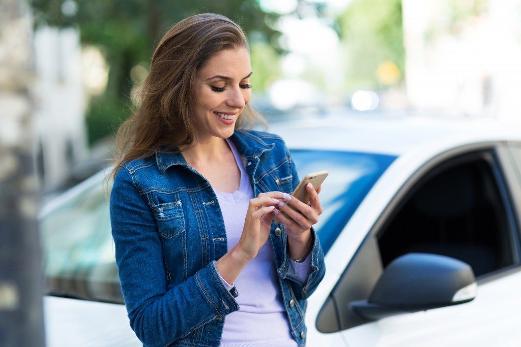 Young woman browsing through her phone