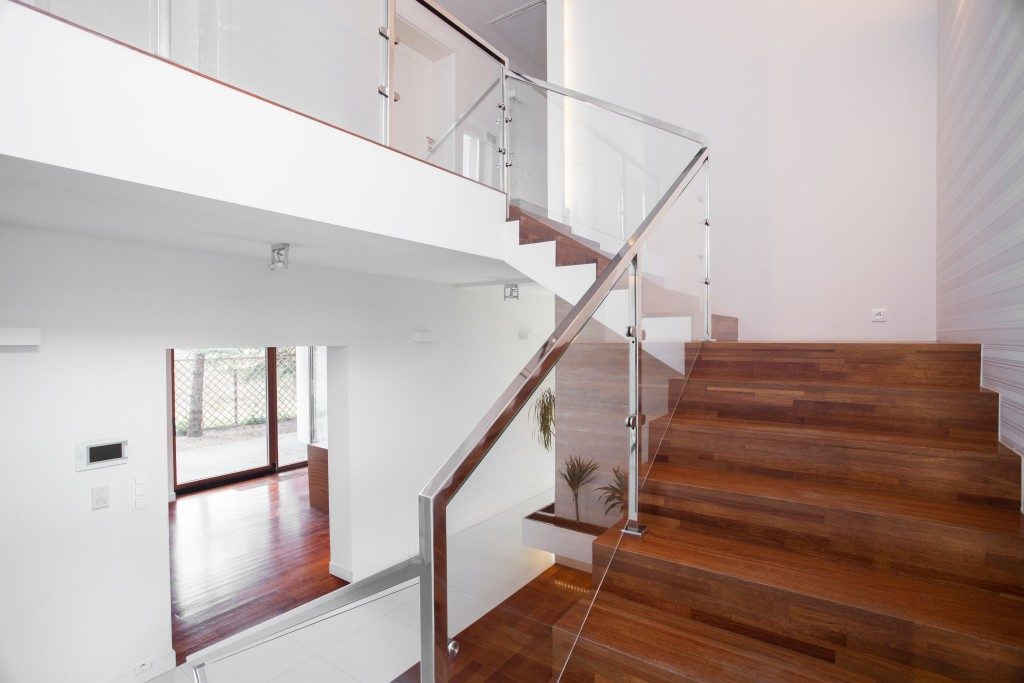 Image of solid wooden stairs with elegant glass balustrade