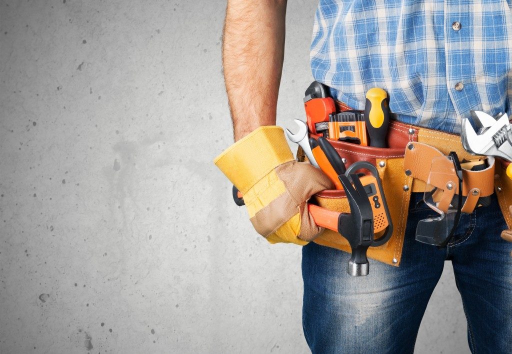 man posed with a tool belt