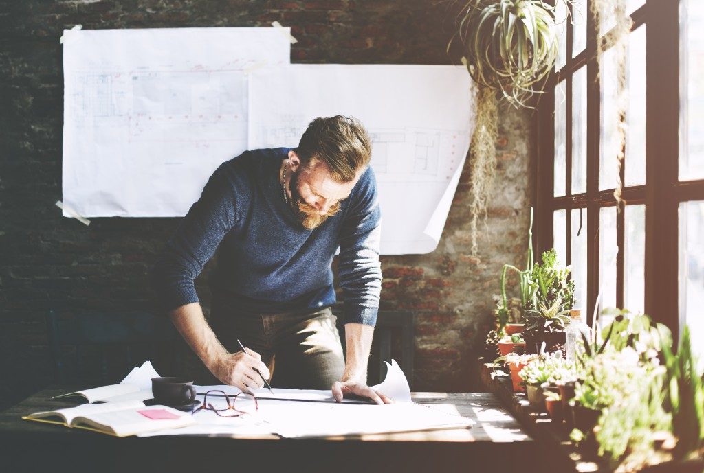 Man working standing up next to his desk