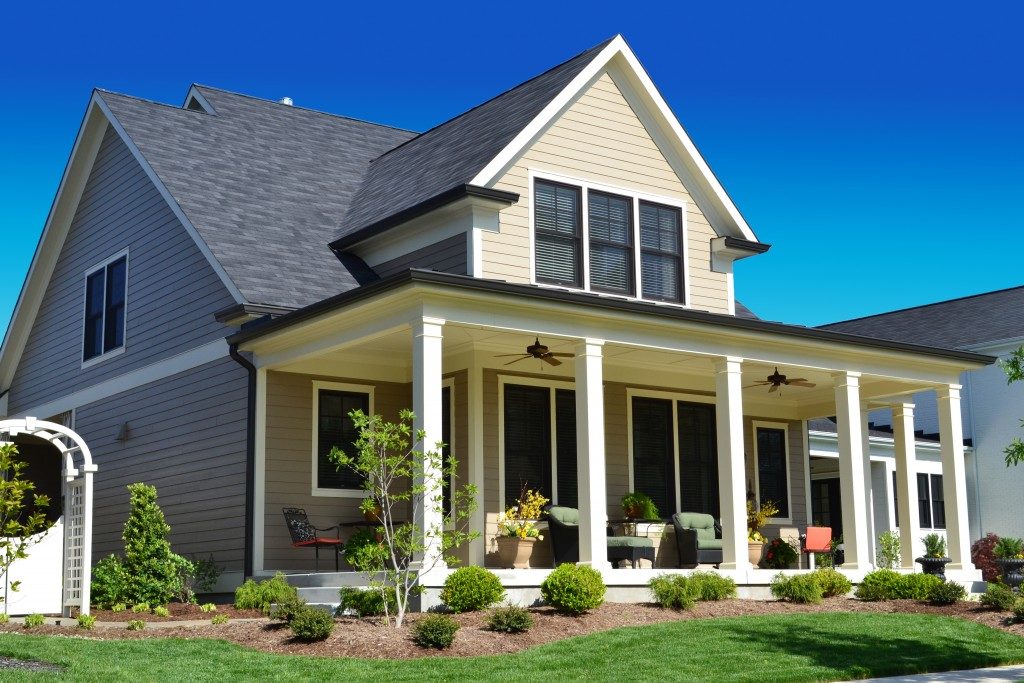 suburban home with plants infront of patio