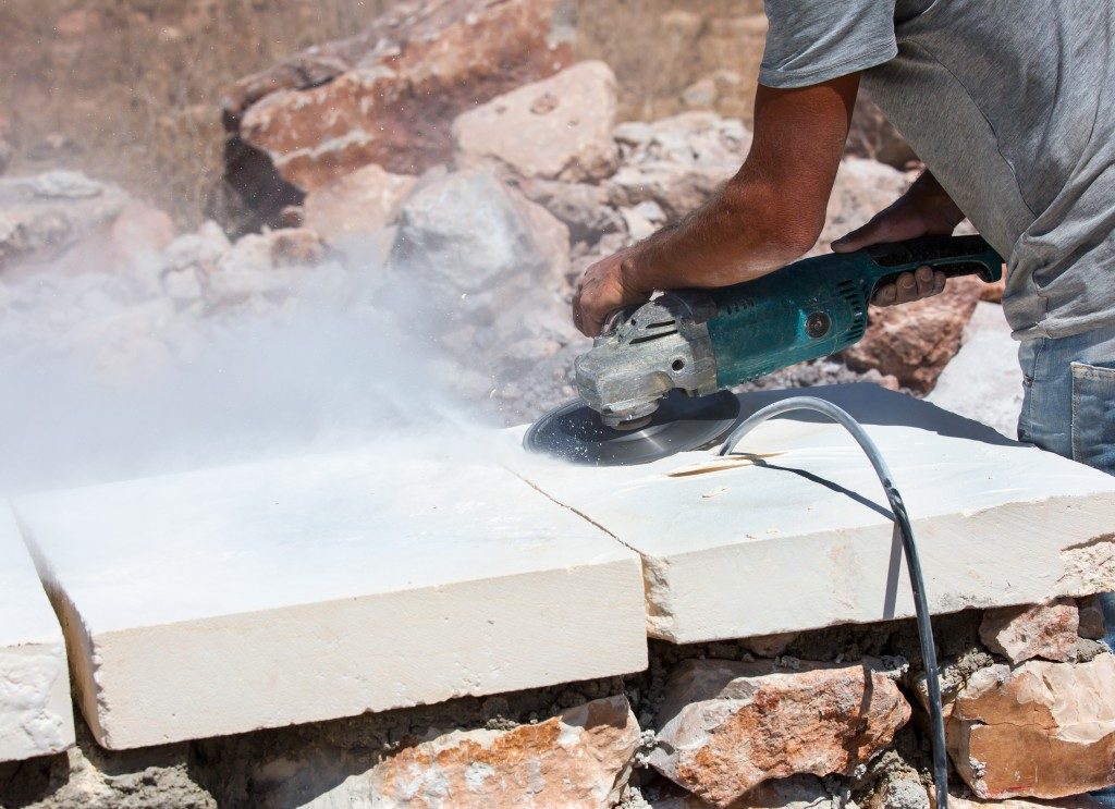 construction worker cutting blocks