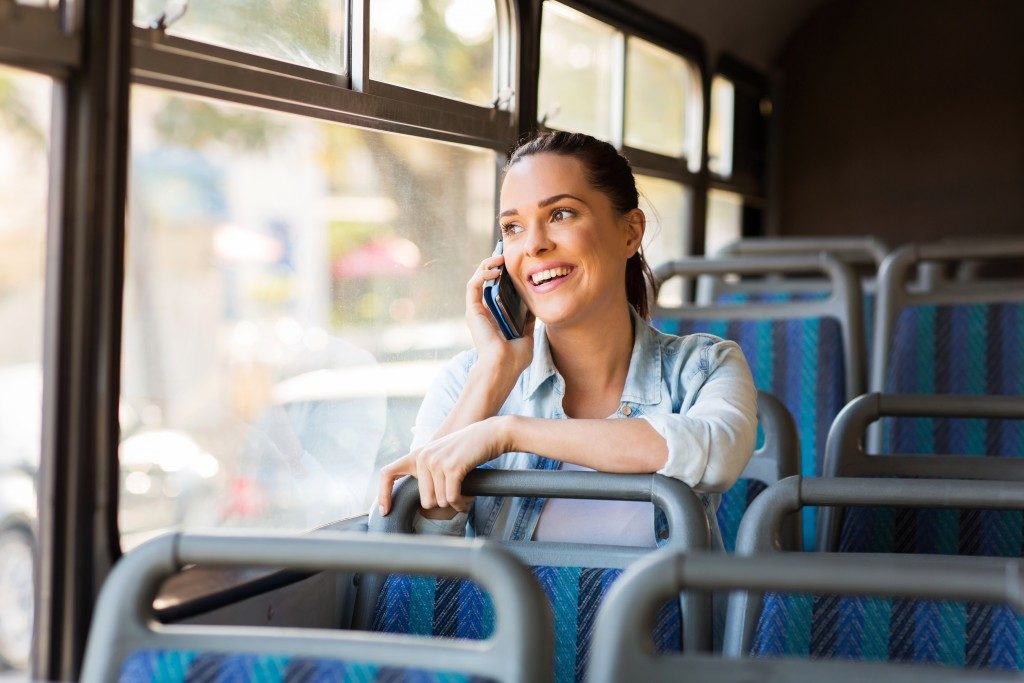 woman in a phone call inside a bus