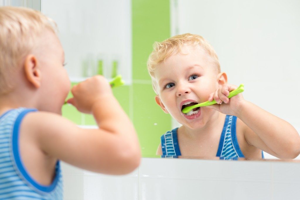 little boy brushing his teeth