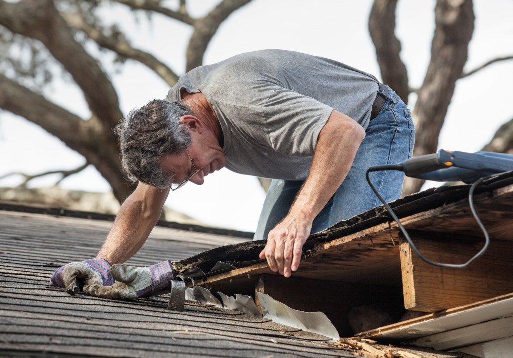 man repairing the roof