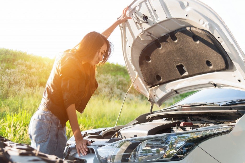 woman checking her car