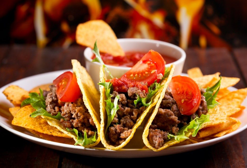 tacos and tomato dip on a plate