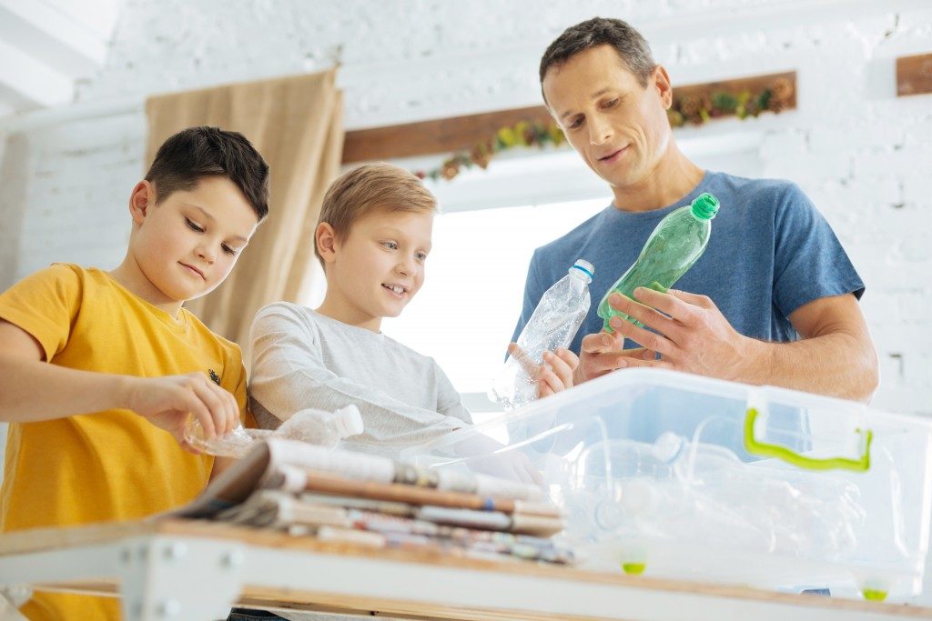 father and his sons segragating their trash