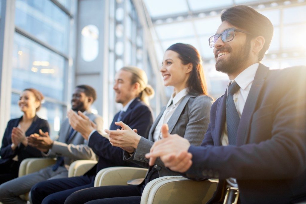 people clapping their hands at an event