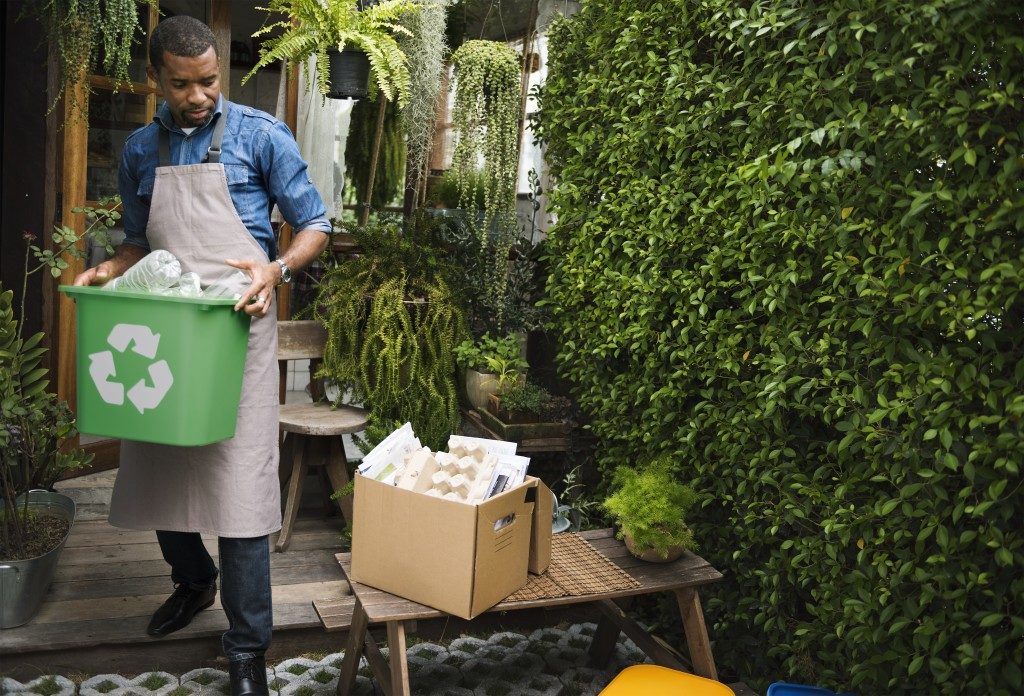 Man carrying container of recycled materials