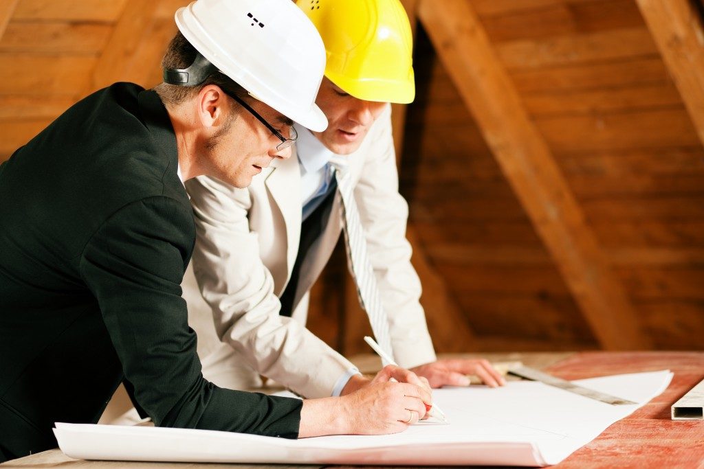 architect and contractor working on plan of house