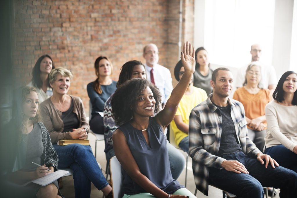 woman raising her hand