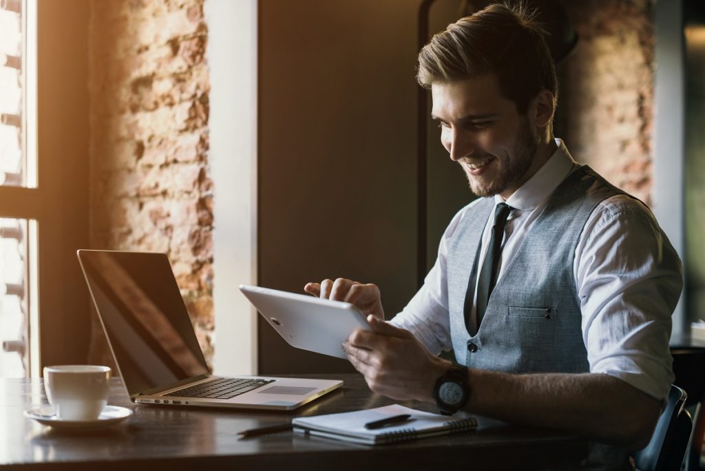 businessman reading something on his tablet