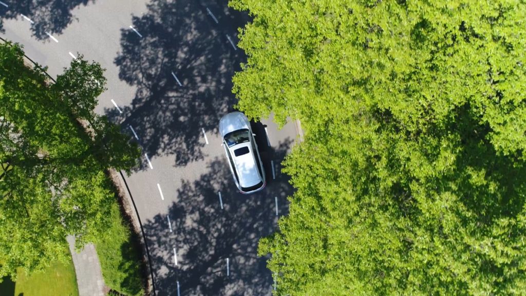 car being followed by a drone from above