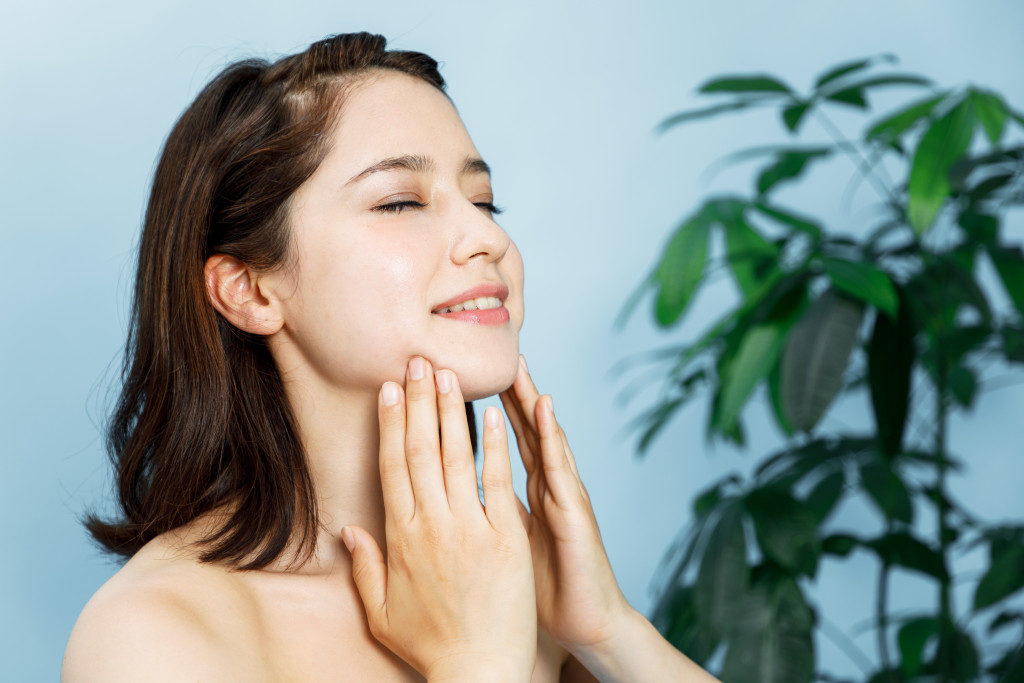 woman massaging her face