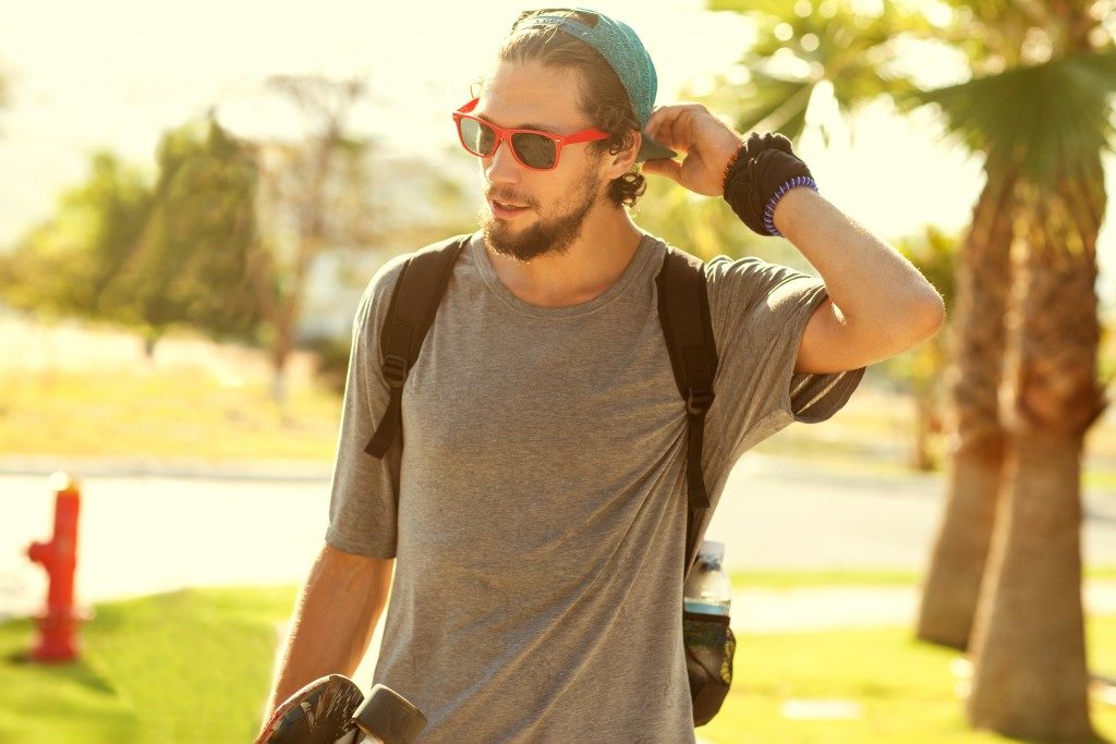 man in plain shirt and sunglasses