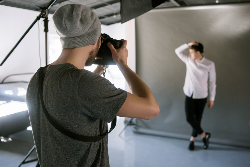 photographer taking a photo of a man posing