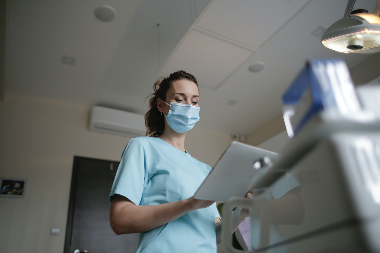 doctor checking stats on a board