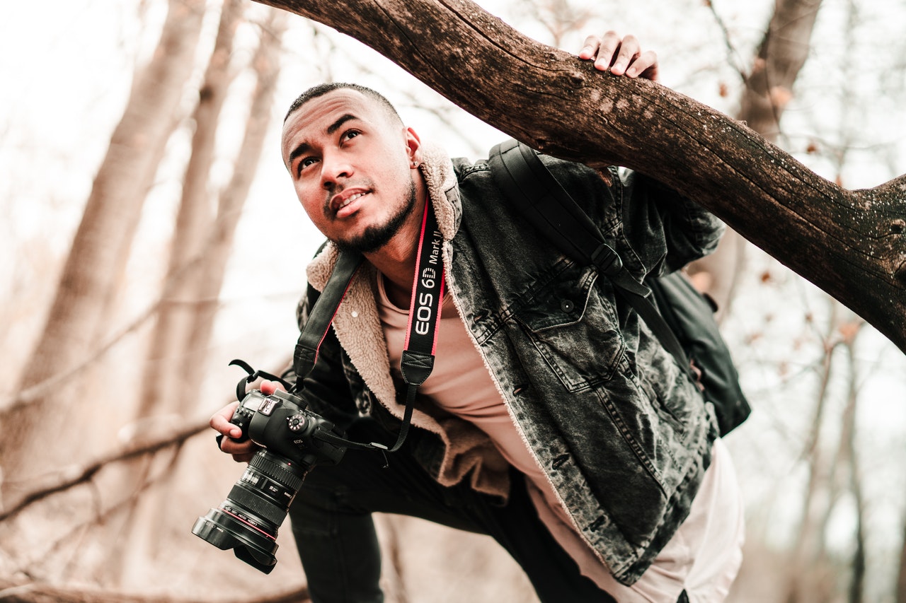 photographer holding camera and branch