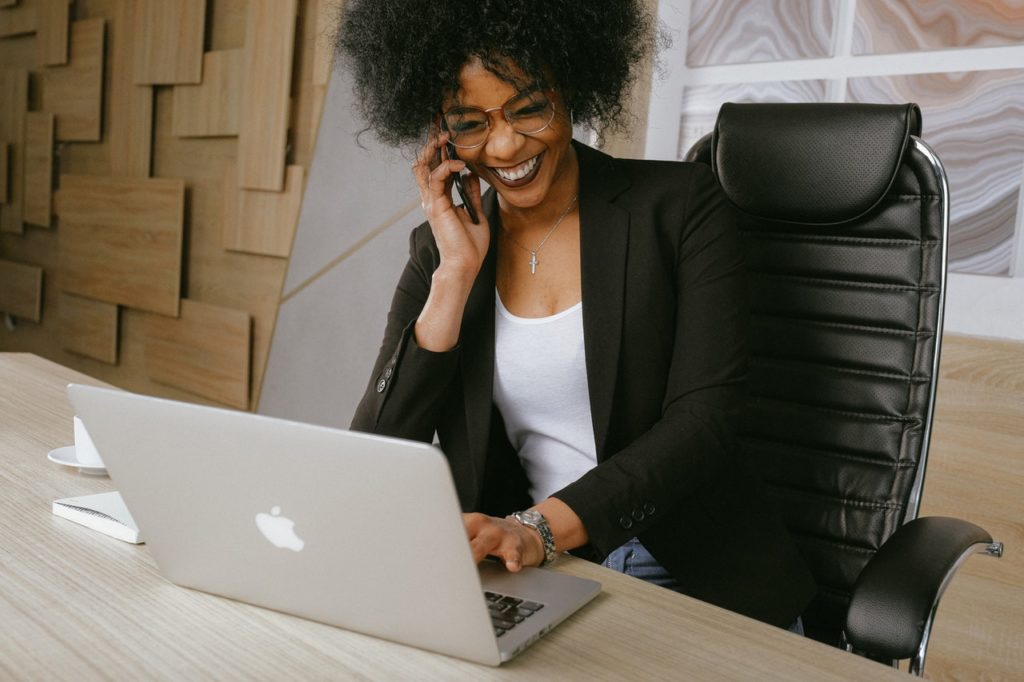 woman smiling at her laptop