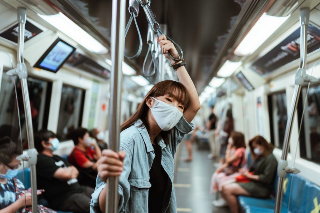 girl at metro rail transit wearing facemask